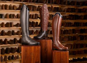 three tall boots on a stand