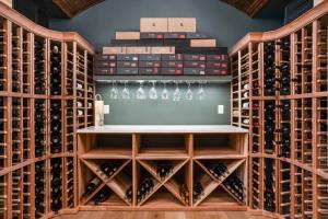 picture of a Wine Cellar in Carmel Indiana design by worthington design & remodeling it  has racking, a temperature controlled environment and a tasting area