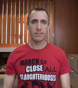 animal rights activist Donny Moss wears a t-shirt messaging slaughterhouses and the coronavirus