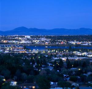 Great Falls MT at night with Rockies in the background