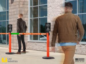 Customers keeping a safe social distance while queuing with the help of printed signage and retractable belt stanchions