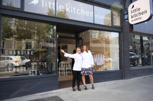 Iron Chef Cat Cora with Little Kitchen Academy founder standing outside in front of the flagship location in Vancouver, BC