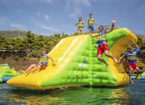 Guests jumping off of the XXL Tower at WhoaZone Whihala Beach