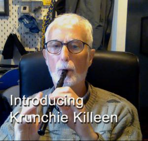 Krunchie Killeen blowing a black tin whistle