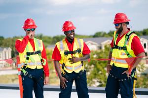Photo capturing A.D. Khrone leading roofing team members on top of a commercial roof.