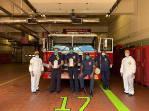 Church volunteers in PPE delivering Stay Well booklets to a fire station