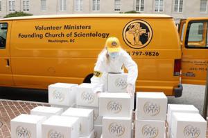 Several thousand Stay Well booklets being distributed by Church of Scientology volunteer