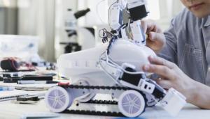 Waind picture of a student working on a robot