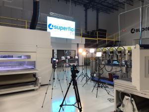 Photograph inside Superfici America's technology center showing TV production cameras and LED wall.