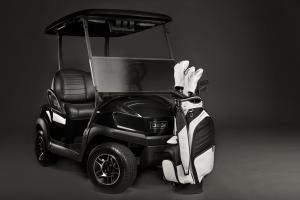 The APEX midsize staff from VESSEL Bags is shown in a black and white colorway. The golf staff bag is modeled with matching golf head covers.