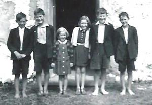 A group of 5 barefoot children, Krunchie at the very right