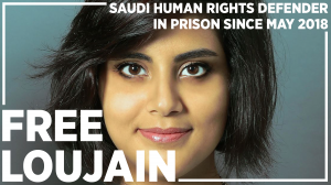 Head shot photo of Loujain AlHathloul, she is smiling, looking directly to camera, dark hair that comes to her chin; written words say: Free Loujain - Saudi Huma Rights Defender in prison since May 2018