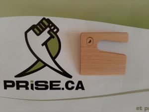 Image of the Prise, Inc., company logo next to an image of the Little Kitchen Academy child safe knife made of wood with the Little Kitchen Academy bird signet/logo in black