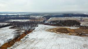 alt="Aerial view with snow of 180-acre research project area at Grant Woods in Ingleside, Ill."