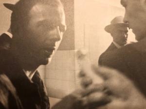 Lee Harvey Oswald attempts to answer a question from a reporter on November 22, 1963. Photograph by James Patrick Murray