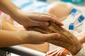 Youthful hands hold elderly hands in warm embrace. Kramer Trial Lawyers, A.P.C. deeply believes in caring for elders and see a concerning trend developing whereby businesses, small and large, are able to shirk their legal responsibilities under certain st