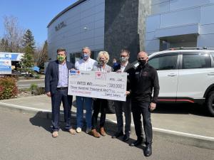 Capitol Auto Group presents $300,000 check to United Way of the Mid-Willamette Valley  at Capitol Subaru.  (L-R) Alex Casebeer, Scott and Carrie Casebeer, Matthew Casebeer, Bob Myers
