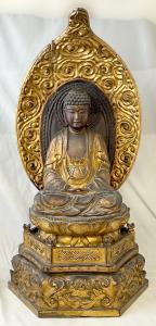 19th century carved and giltwood Buddha temple figure on a lotus base. Estimate: $400-$600.
