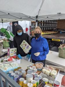 Masked young man and mom organize truck cans during pandemic.