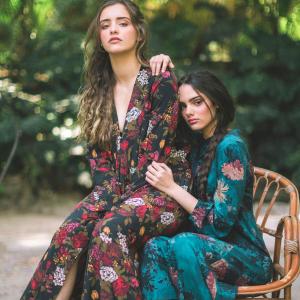 Two beautiful women dreased in long floral dresses reming us o the cottage-core trend.