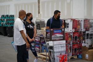 Volunteer Assists Family at The Big Giveaway