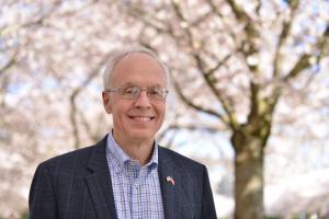 Bud Pierce, MD, Candidate for Oregon Governor, outside on the grounds of the Capitol building with cherry blossoms in the background