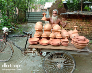 Photo: older man with a cart filled with clay pots.