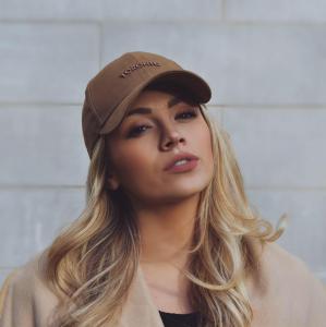 Samantha Gracie, blonde woman wearing brown hat with Toronto written on it
