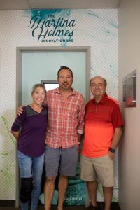 Three Munsch family members pose at the door of PetDine's Martina Holmes Innovation Lab.