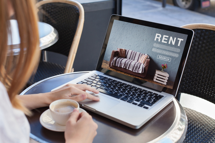Online rental concept, woman using website for renting apartments, houses and apartments