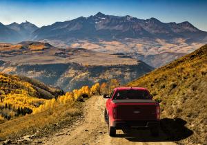 red 2019 2020 2021 2022 2023 2024 Ford Ranger 5' bed with flat sawtooth stretch truck bed cover on a fall mountain road sawtooth stretch tonneau cover on a fall mountain road