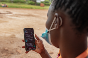 A Ugandan woman uses StrongMinds' free teletherapy services.