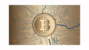 image of a bitcoin on a metal sheet of cryptocurrency
