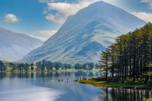 Buttermere Lake surrounded by a green hill in the Lake District in England
