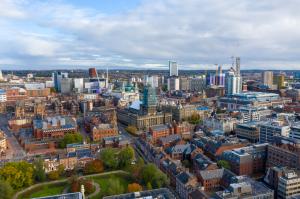 Aerial photo of Leeds city center in the UK showing Leeds Town Hall with construction work in progress on the tower