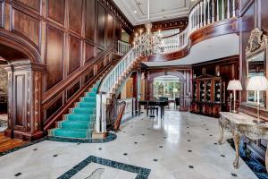 Two-story foyer with marble floors and luxury finishes