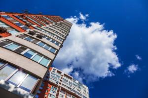 New residential high-rise building in a residential settlement against a clear blue sky