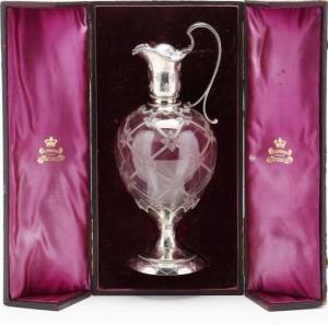 12 inch tall silver and cut glass wine container in original silk-lined case, with badges from King, Elkington and Co. (estimate: $ 2,500 to $ 5,000).