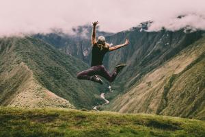 Energetic girl jumping while hiking