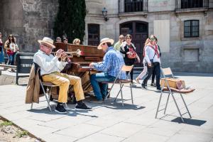 A piano and trombone playing outside a church in Barcelona.