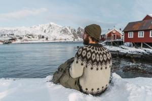 Matthew Keezer sitting on a rockface in Norway