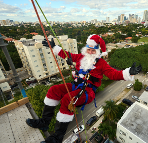Santa Claus rappels over a 10-story building to support Youth For Christ Miami