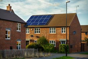Photovoltaic solar panels fitted to a new roof of single family homes, England