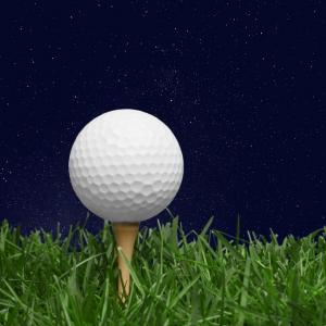 Golf ball on tee at night