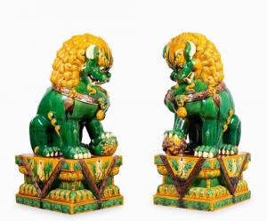 Monumental pair of seated Buddhist lion figures in Chinese Sancai glaze ceramic on stands, 57 inches tall ($5,938).