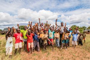 African children in front of solar array