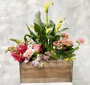 Large spring floral arrangement in a wooden planter