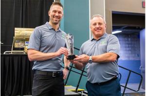 MPI staff Kyle Rhodes and Frank Reda accept IAOM Best of Show award for Intell-I-Mag