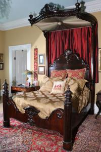 Rosewood rococo half tester plantation bed by C. Lee, with a carved crown and finials, 11 feet 2 inches in height (est. $12,000-$15,000).