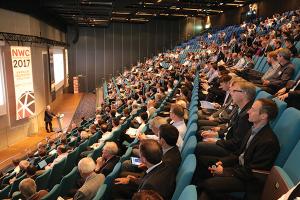 Participants in a packed auditorium listen to a presentation at a previous NAFEMS World Congress